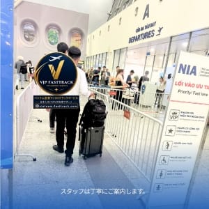 VIP FastTrack entrance at an airport with staff guiding travelers in a dedicated security lane passengers with luggage in line behind glass barriers